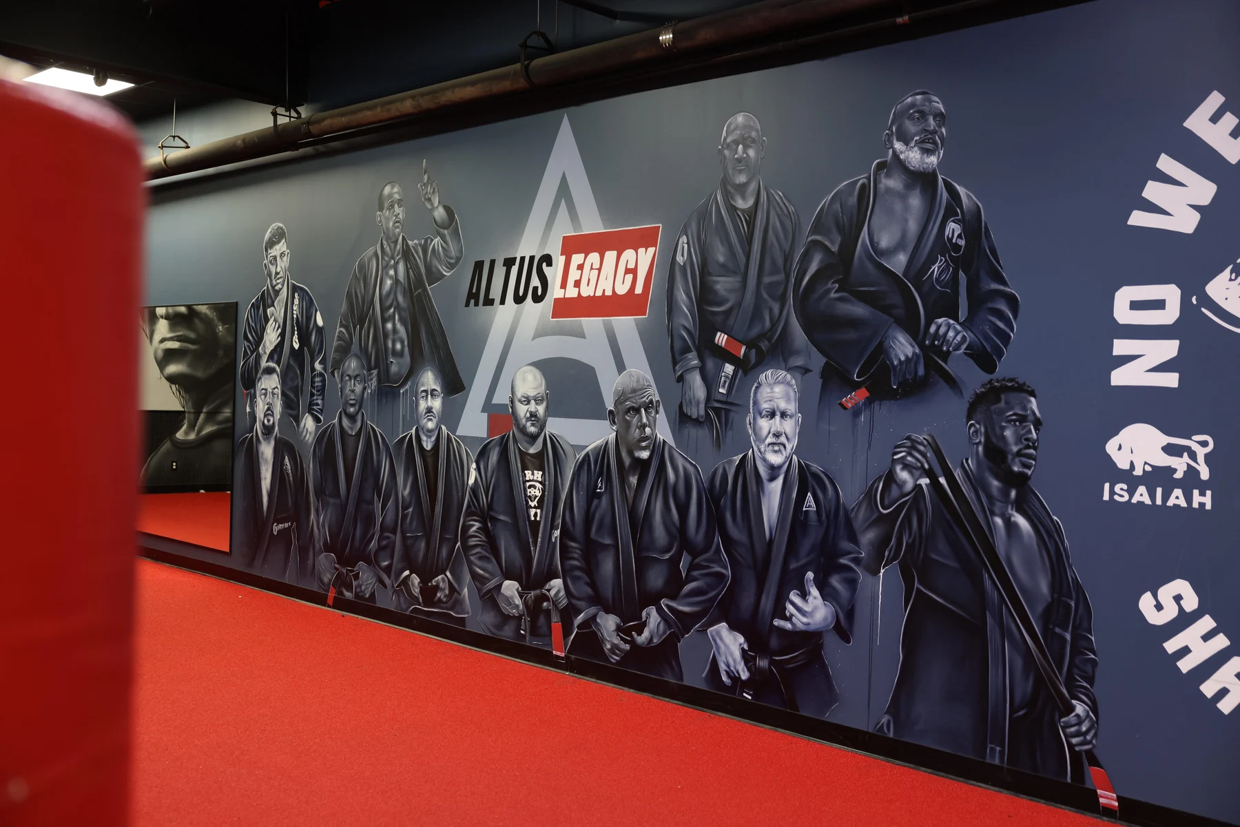 The Altus academy legacy mural beside the training mats