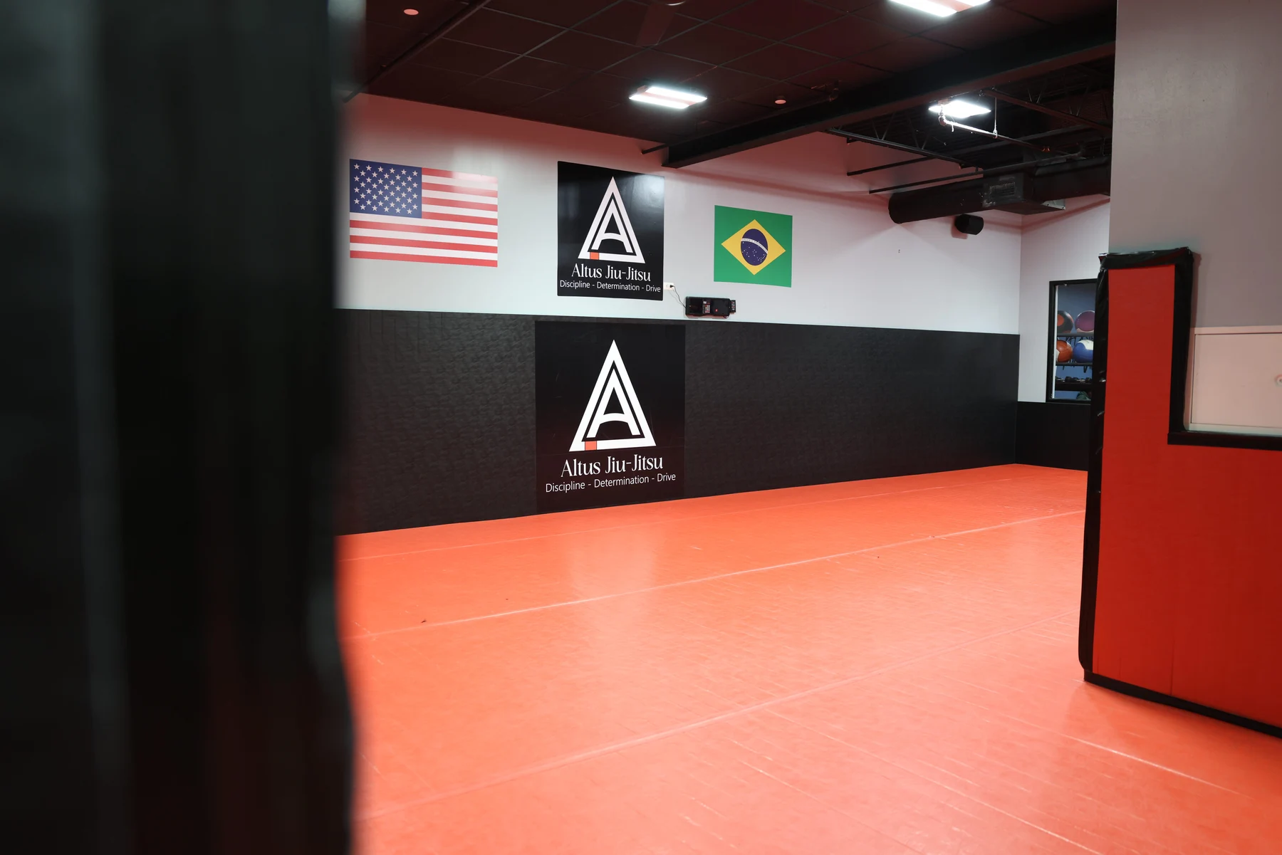 The Altus academy training floor and wall emblem