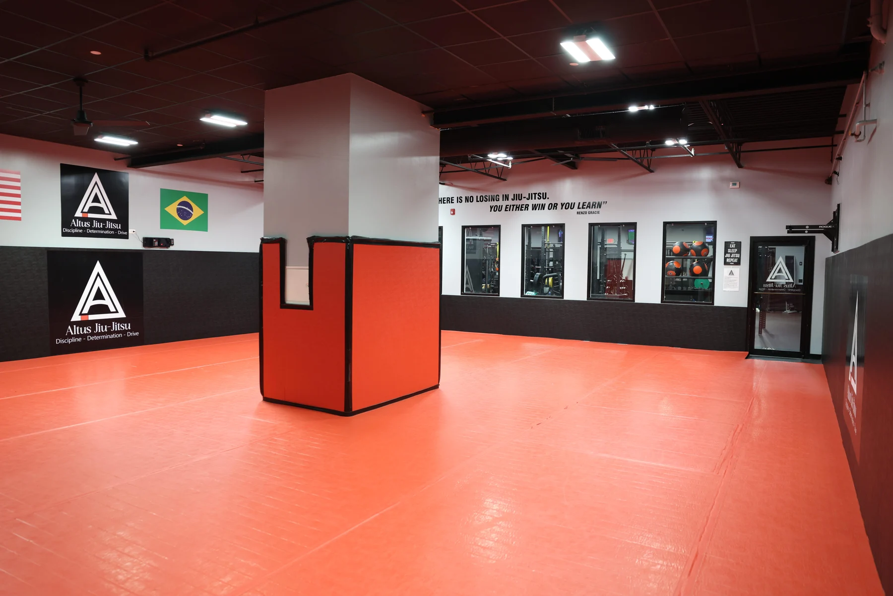 The red training mats and academy interior at Altus in Brewster