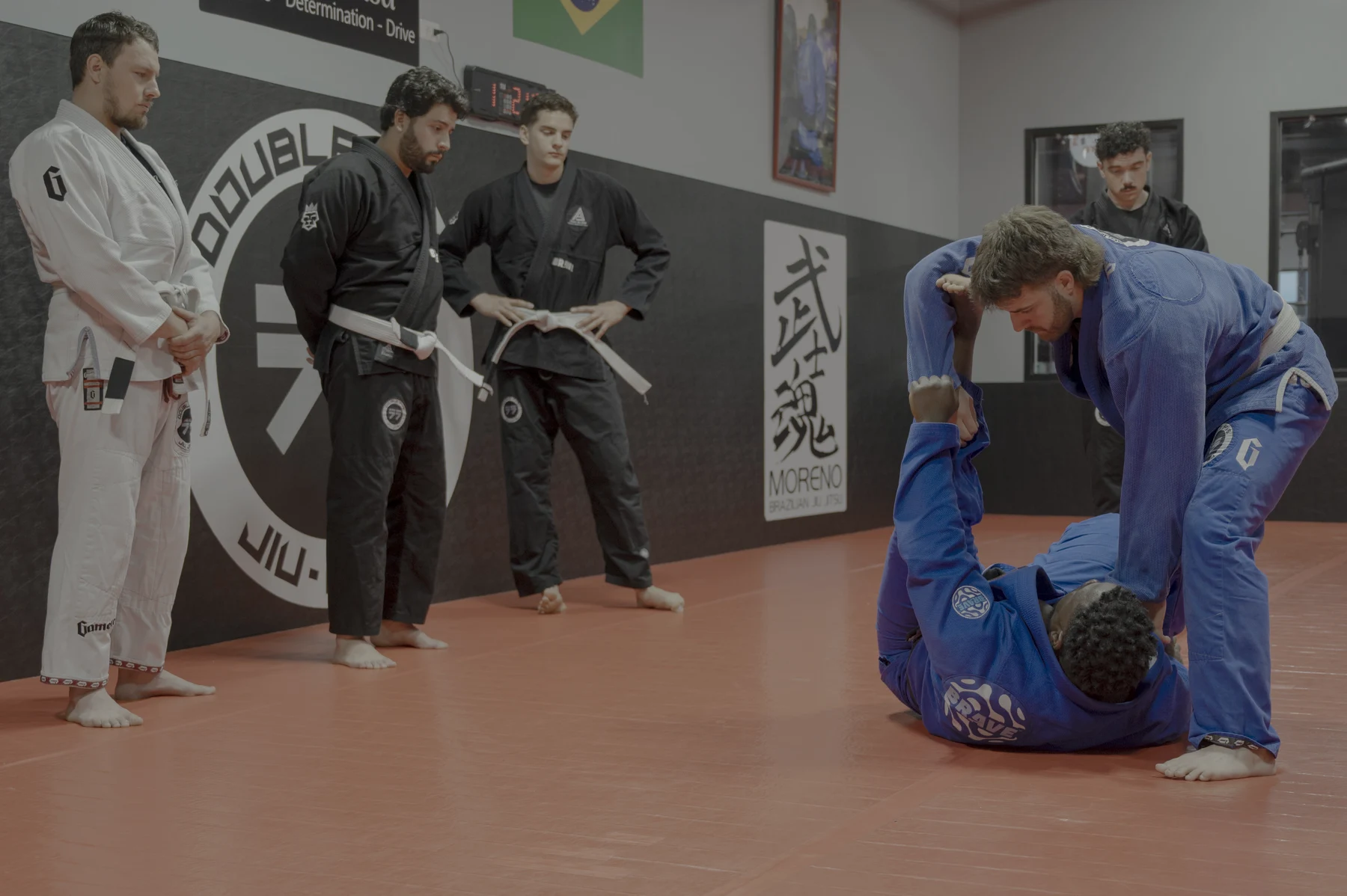 An instructor demonstrating grips while students watch