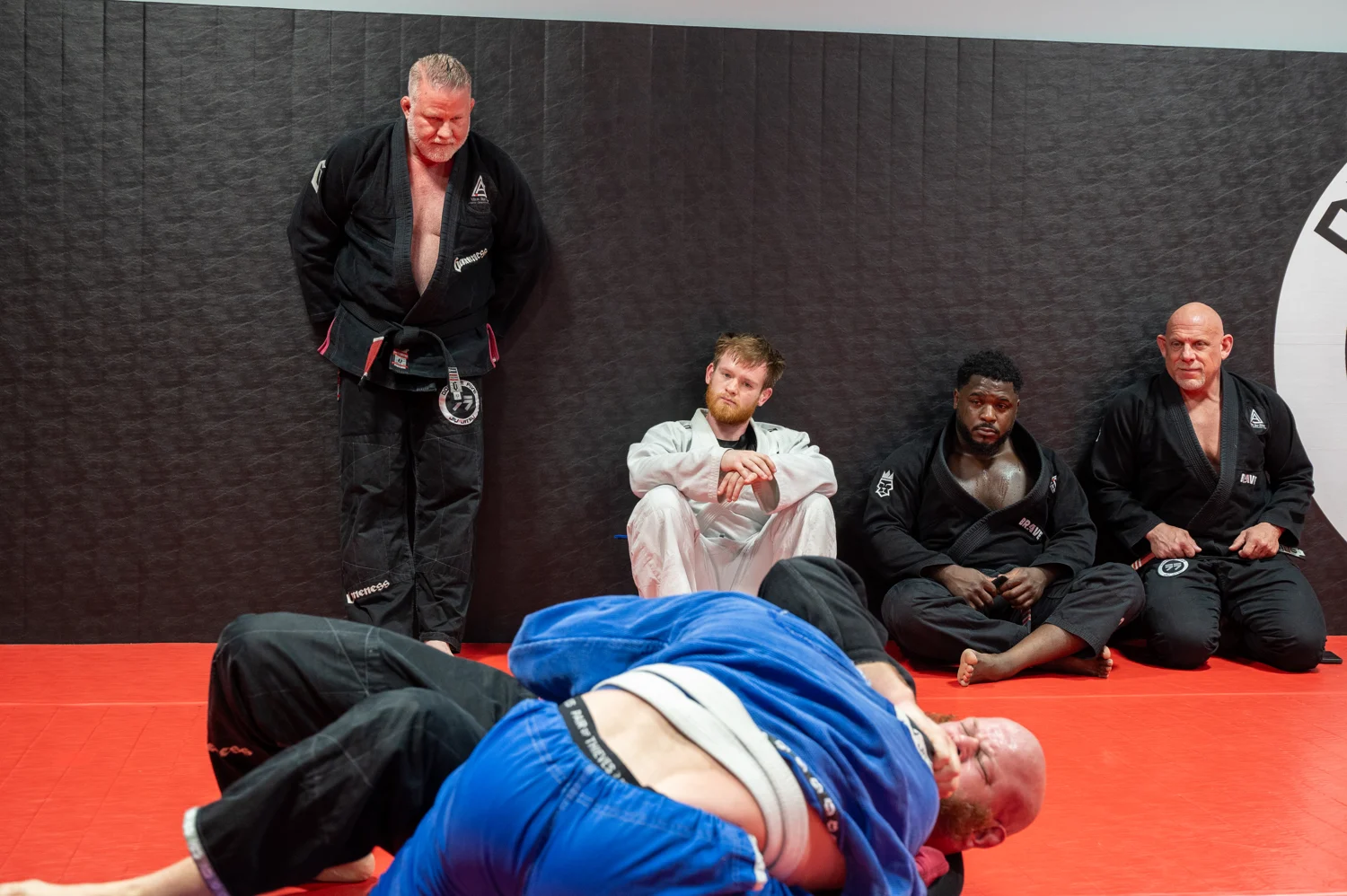 Students watching an instructor demonstrate a technique on the Altus mats
