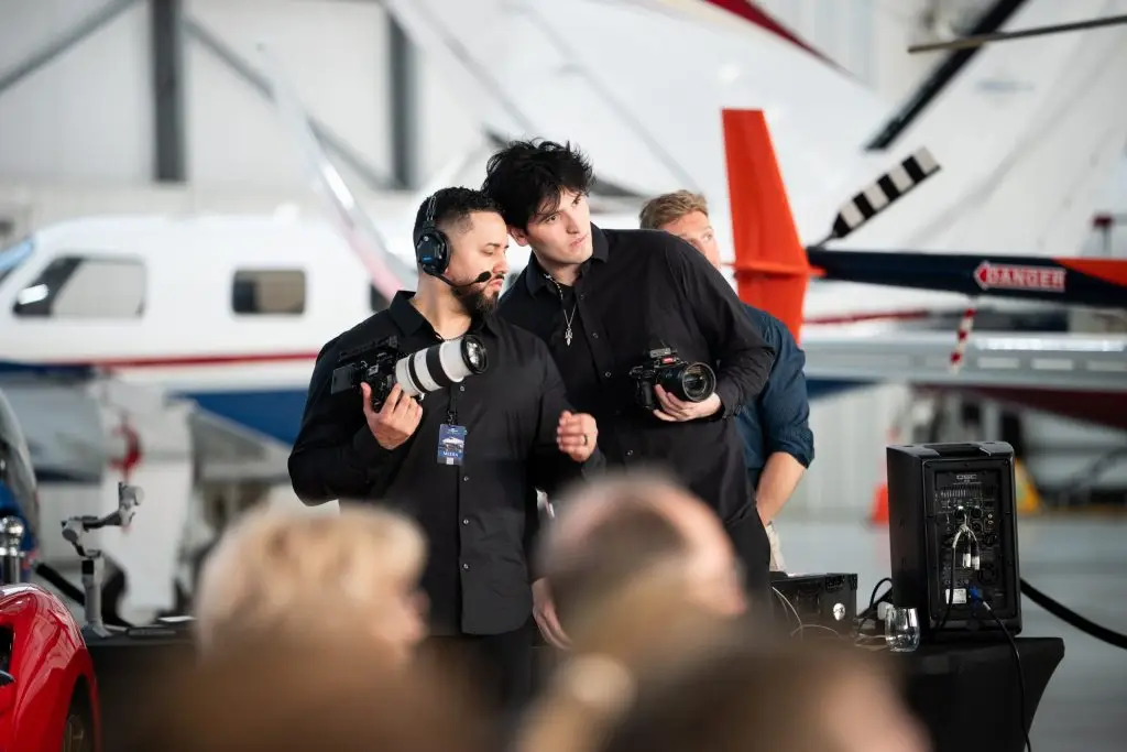 Two camera operators working together at an event