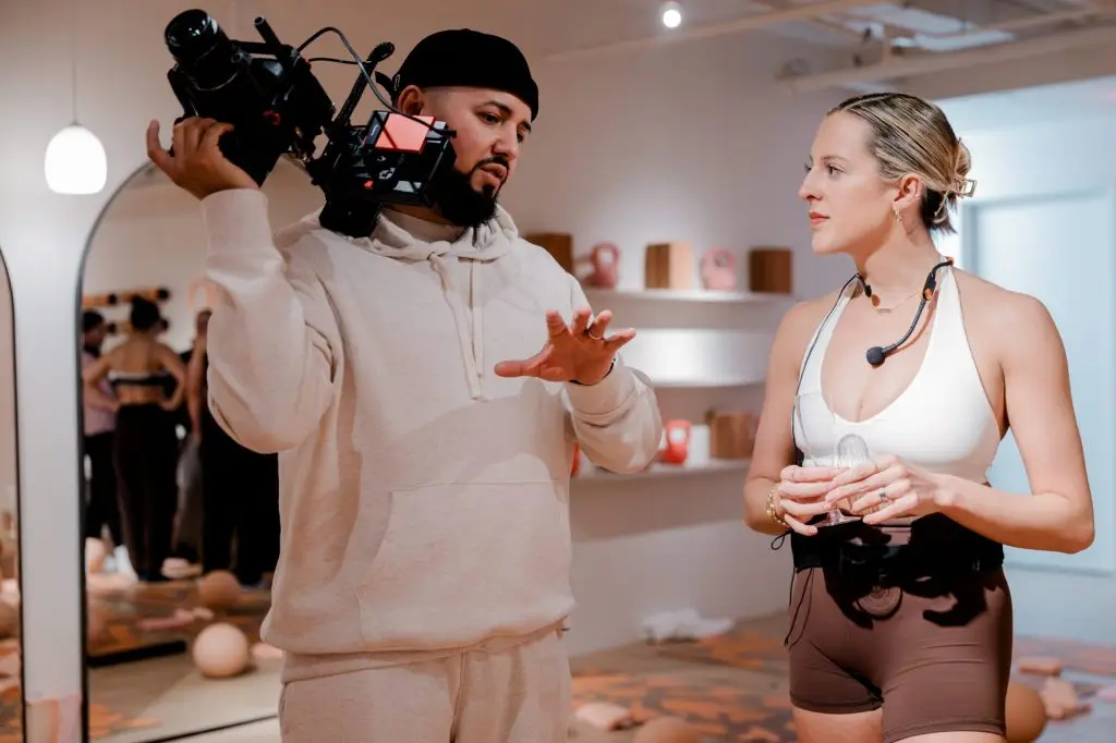 Luis Rivera operating a shoulder-mounted cinema camera on set